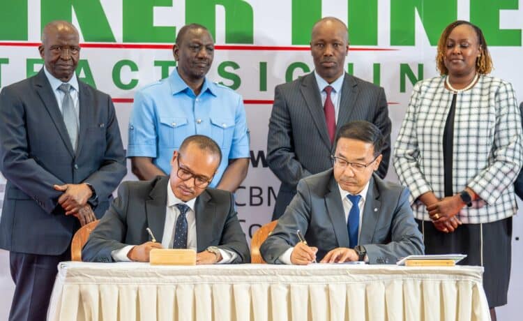 Amsons Group Managing Director, Mr Edha Nahdi (foreground left) and Sinoma CBMI Chairman, Mr Zhang Sicai (fore right), signing the US$250 million Matuga Clinker Factory Construction contract, witnessed by President William Ruto, Bamburi Cement Plc Chairman John Simba, MITI CS Lee Kinyanjui and Bamburi Cement Head of Legal and Company Secretary Joyce Munene. Image/Bamburi Cement Plc