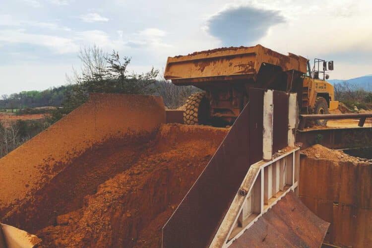 Without flow aids, accumulation of material is common throughout cement manufacturing, from quarry to load-out of the finished product. Image: Martin Engineering